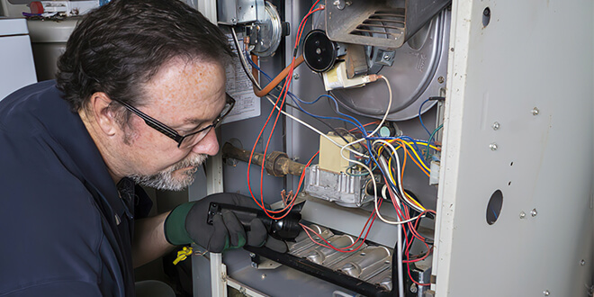 Furnace Cleaning Bonney Lake, technician working in a furnace
