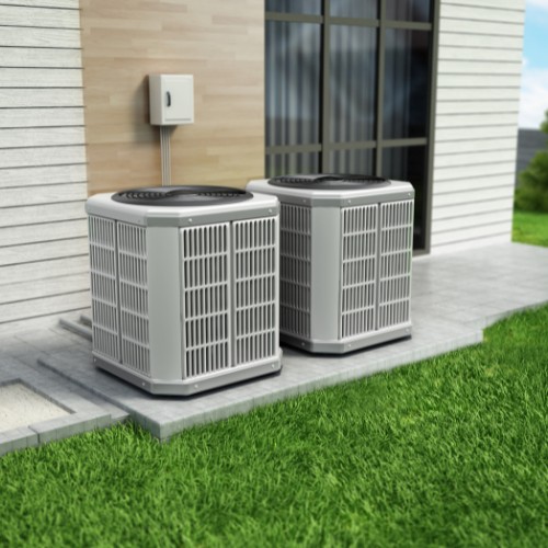 Two hybrid heat pumps outside a home
