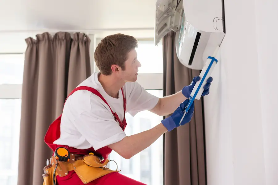 hvac worker performing a mini split maintenance